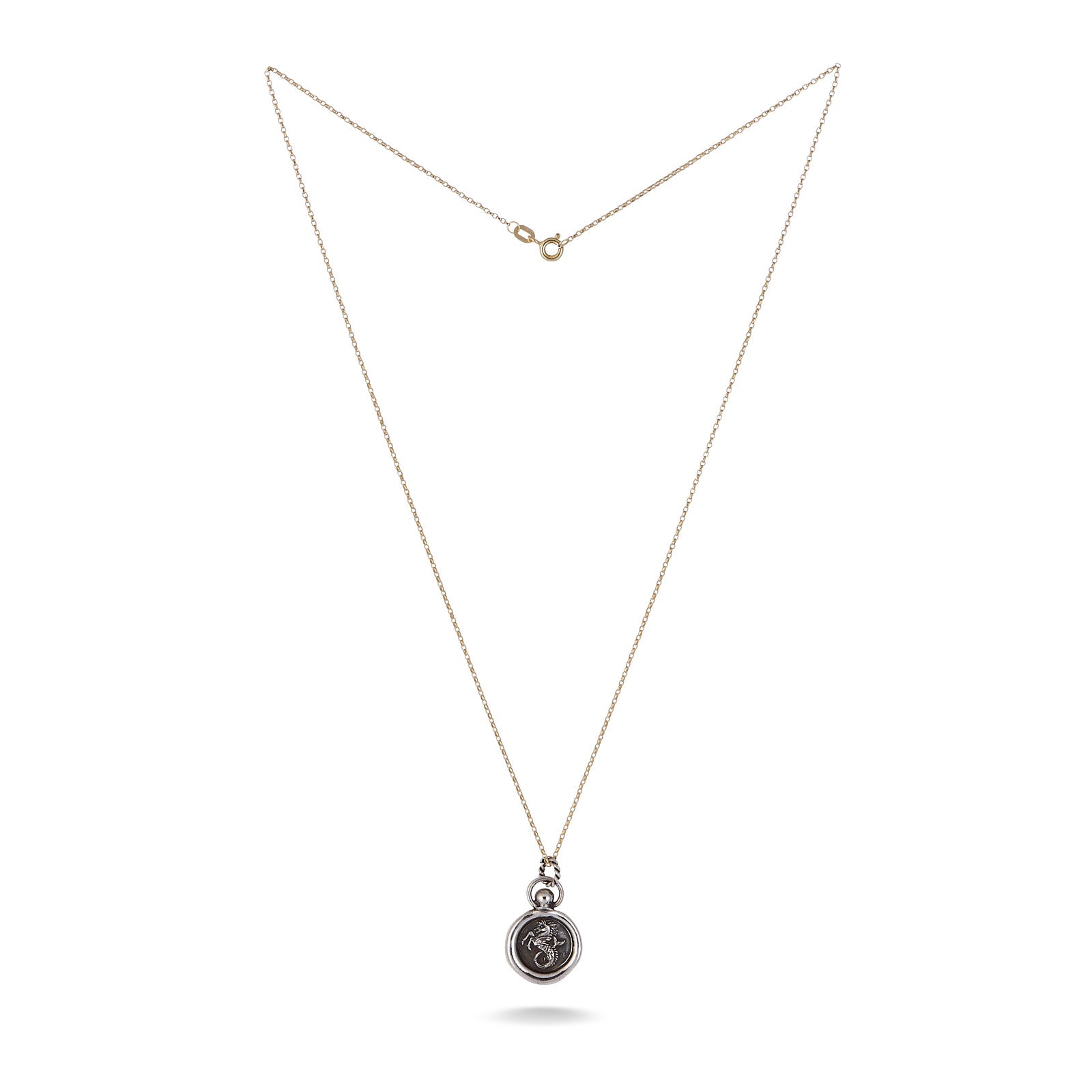 The House of the Dragon & JdL Velaryon Wax Seal Charm by Jessica de Lotz Jewellery features a thin gold chain and round silver pendant with a floral motif, displayed unclasped and elegantly centered on a white background.