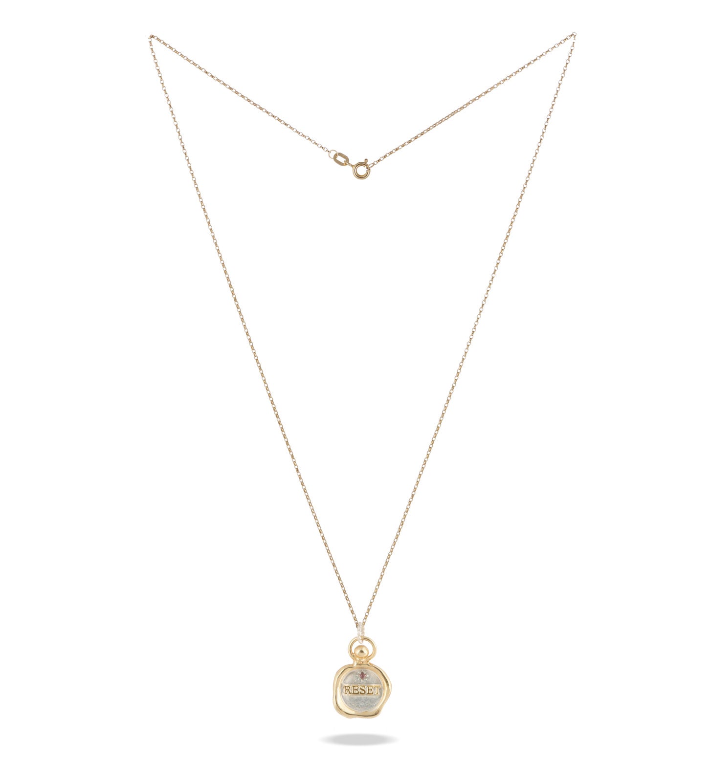 The Jessica de Lotz Jewellery RESET charm is a delicate gold necklace with a thin chain and small round pendant engraved "RESET," inspired by New Beginnings. This Limited Edition Wax Seal Charm is shown fully extended on a plain white background.