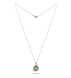 The RESET charm by Jessica de Lotz Jewellery features a delicate gold chain and a small round silver pendant engraved with “RESET.” Displayed on a white background, it symbolizes new beginnings—an ideal accessory for fresh starts.