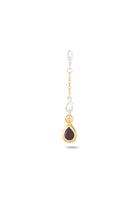 The “My Blood, Your Blood, Our Blood Charm” by Jessica de Lotz Jewellery features a single gold and silver earring adorned with a delicate loop, chain with beaded accents, and a teardrop-shaped red gemstone set in a gold bezel. Evoking the spirit of sisterhood and inspired by Practical Magic charms, this piece symbolizes meaningful connection and subtle enchantment. Photographed on a white background with a soft shadow beneath, it beautifully captures its magical allure.