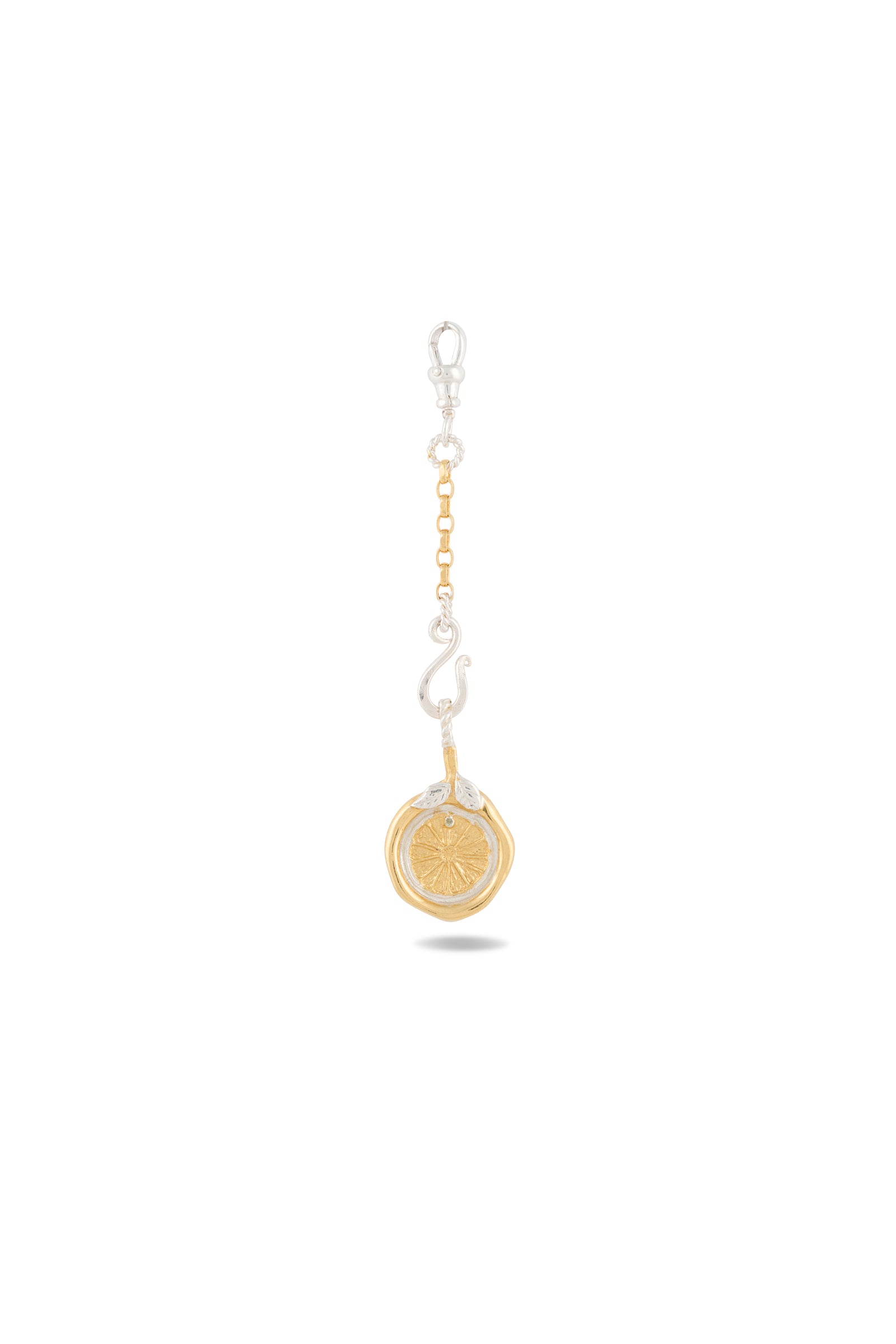 Introducing the Midnight Margarita Lime Charm Keychain by Jessica de Lotz Jewellery—an updated take on modern-day chatelaine style. Featuring a lobster clasp, chain links, and a vibrant lime slice charm in zesty yellow-green with white accents, this accessory boasts elegant silver and gold metal details. Perfect for fans of kitchen witchcraft or lovers of Practical Magic-inspired charms, the keychain casts a subtle shadow against its white backdrop.