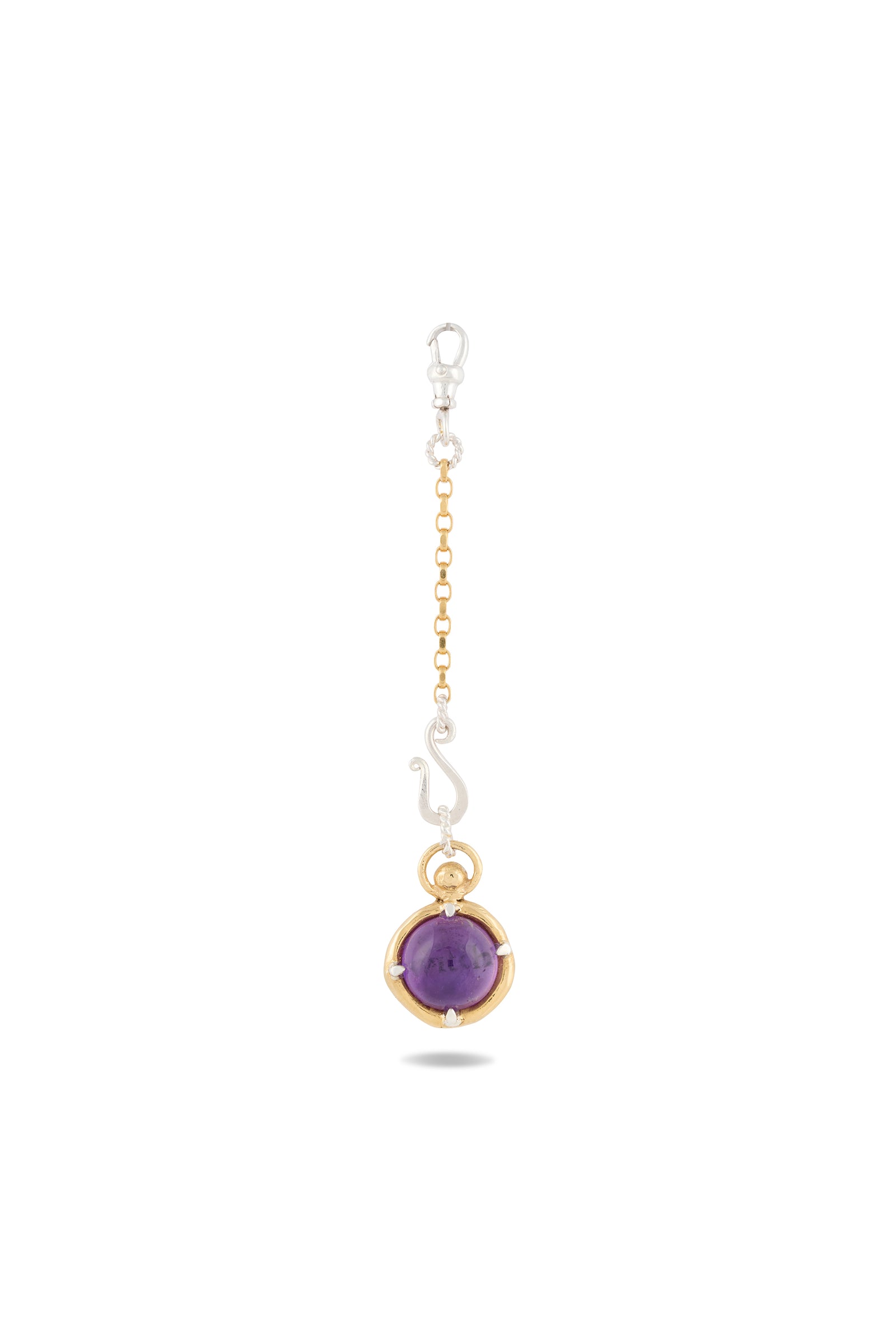Introducing the ’There’s A Little Witch In All Of Us’ Charm by Jessica de Lotz Jewellery: a striking keychain featuring a petite cat charm perched atop a lustrous amethyst cabochon, set within a gleaming gold bezel. The piece is elegantly suspended from a gold chain and secured with a silver lobster clasp. Reminiscent of a modern-day chatelaine, this enchanting accessory channels the mystique of Practical Magic charms. Photographed against a white background.