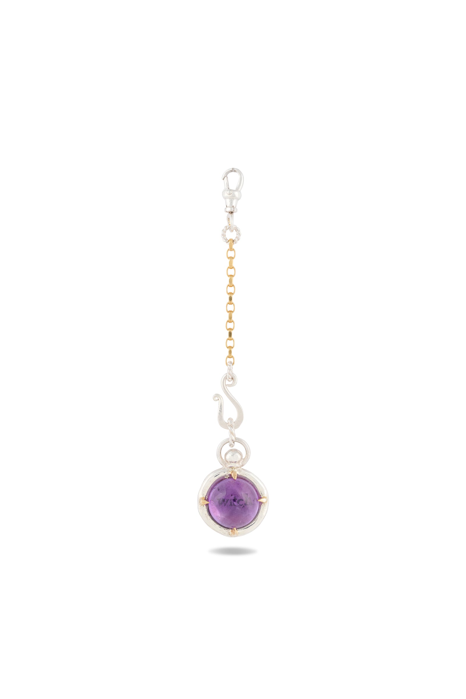 A gold and silver chain with a lobster clasp displays the ’There’s A Little Witch In All Of Us’ Charm by Jessica de Lotz Jewellery—a round amethyst cabochon set in silver. The pendant, echoing the style of a modern-day chatelaine, features metallic accents and is photographed against a white background to highlight the stone’s polished surface and vibrant hue.