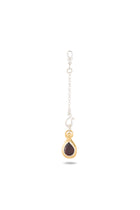Introducing the Jessica de Lotz Jewellery “My Blood, Your Blood, Our Blood Charm”: a delicate chain with a clasp and hook that culminates in a teardrop-shaped pendant. Reminiscent of sisterhood jewelry, this pendant showcases a dark red gemstone set in a gold frame with a small gold accent above it, all elegantly displayed against a white background.