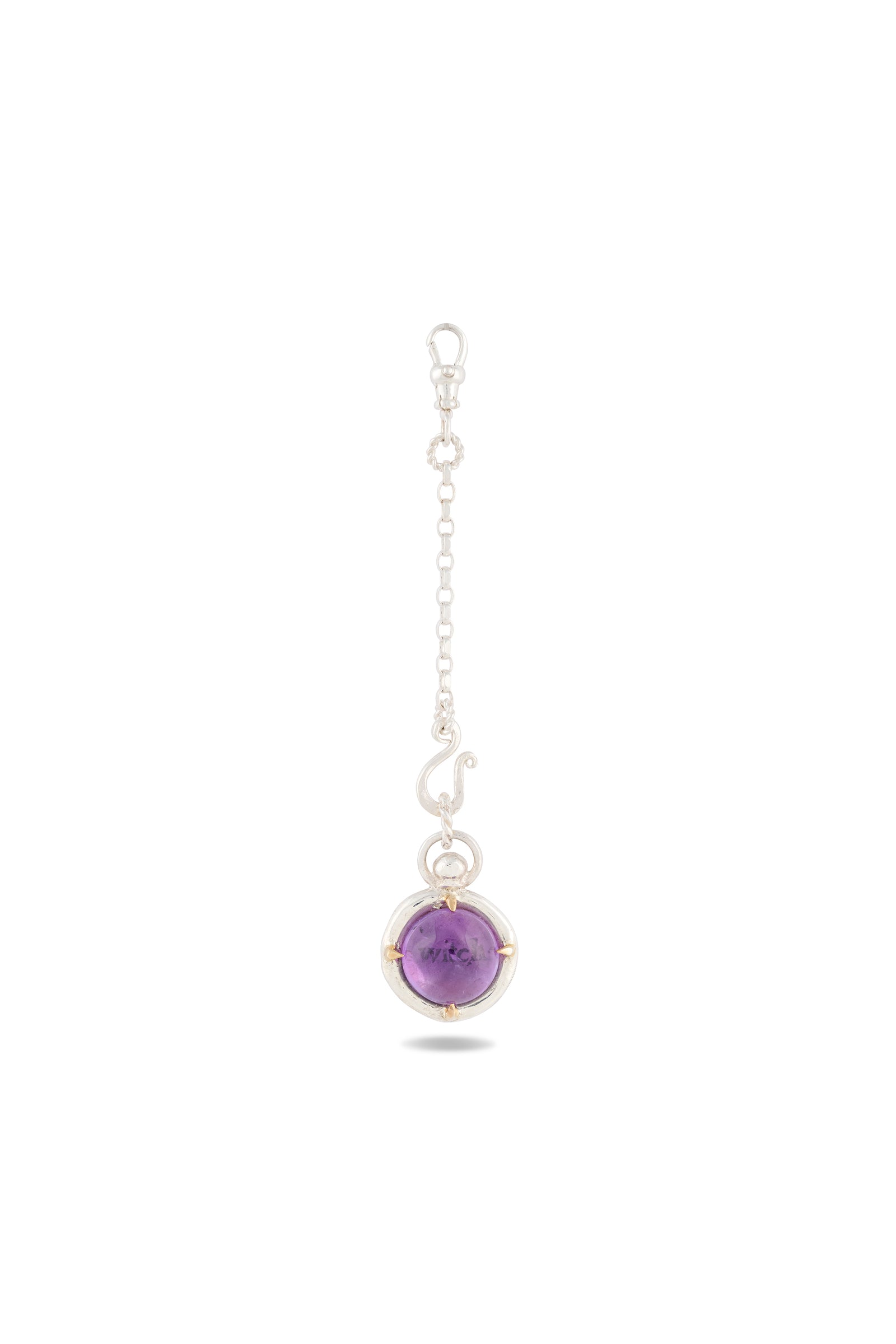 The ’There’s A Little Witch In All Of Us’ Charm by Jessica de Lotz Jewellery showcases a round, polished amethyst cabochon secured in a delicate wire cage and suspended from a fine silver chain with small links and a clasp at the top. Reminiscent of a modern-day chatelaine, the gemstone charm hangs gracefully at the bottom, set against a plain white background.