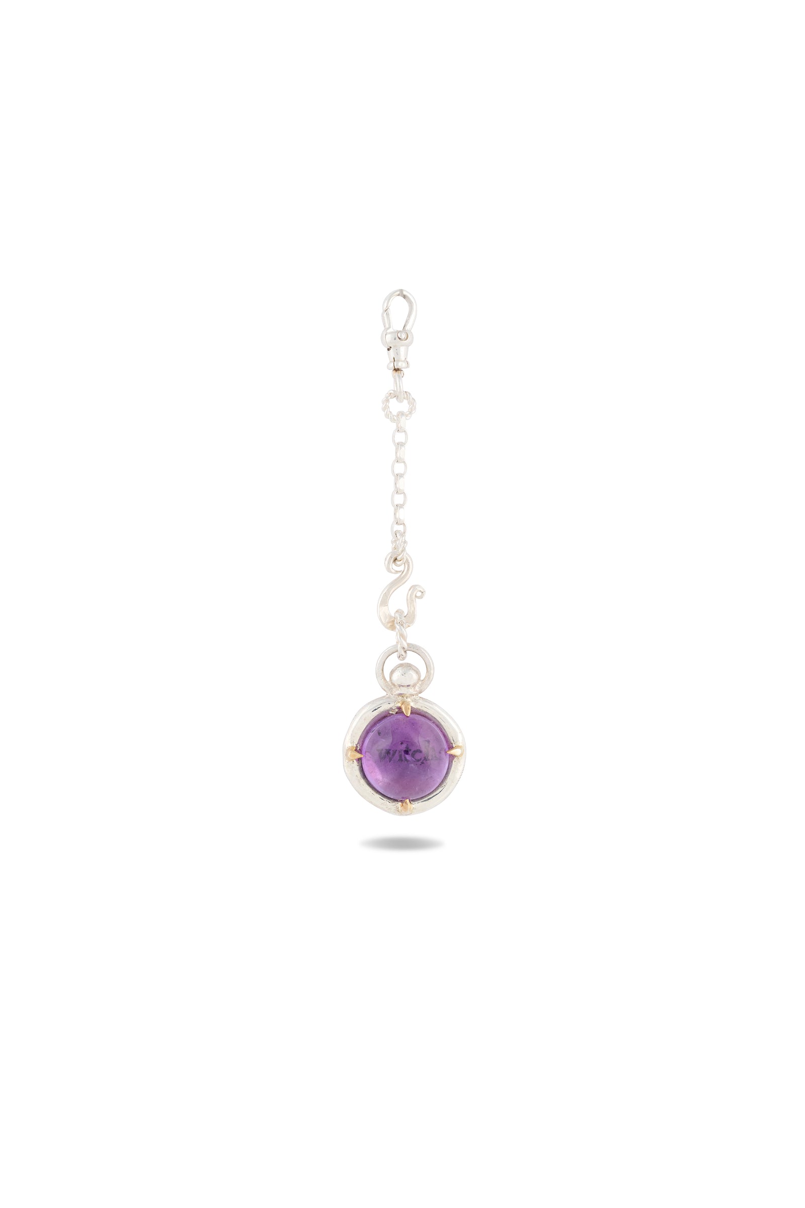 A delicate silver keychain from Jessica de Lotz Jewellery, the ’There’s A Little Witch In All Of Us’ Charm, features a round amethyst cabochon encased in a silver setting. Reminiscent of a modern-day chatelaine, the keychain is designed with a lobster clasp and a short chain of small decorative links, displayed on a plain white background with a faint shadow beneath.
