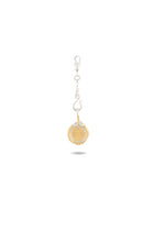 A gold Midnight Margarita Lime Charm by Jessica de Lotz Jewellery, featuring a sunburst design, hangs from a silver chain and clasp; evocative of modern-day chatelaine style, the charm casts a faint shadow below, centered on a white background.
