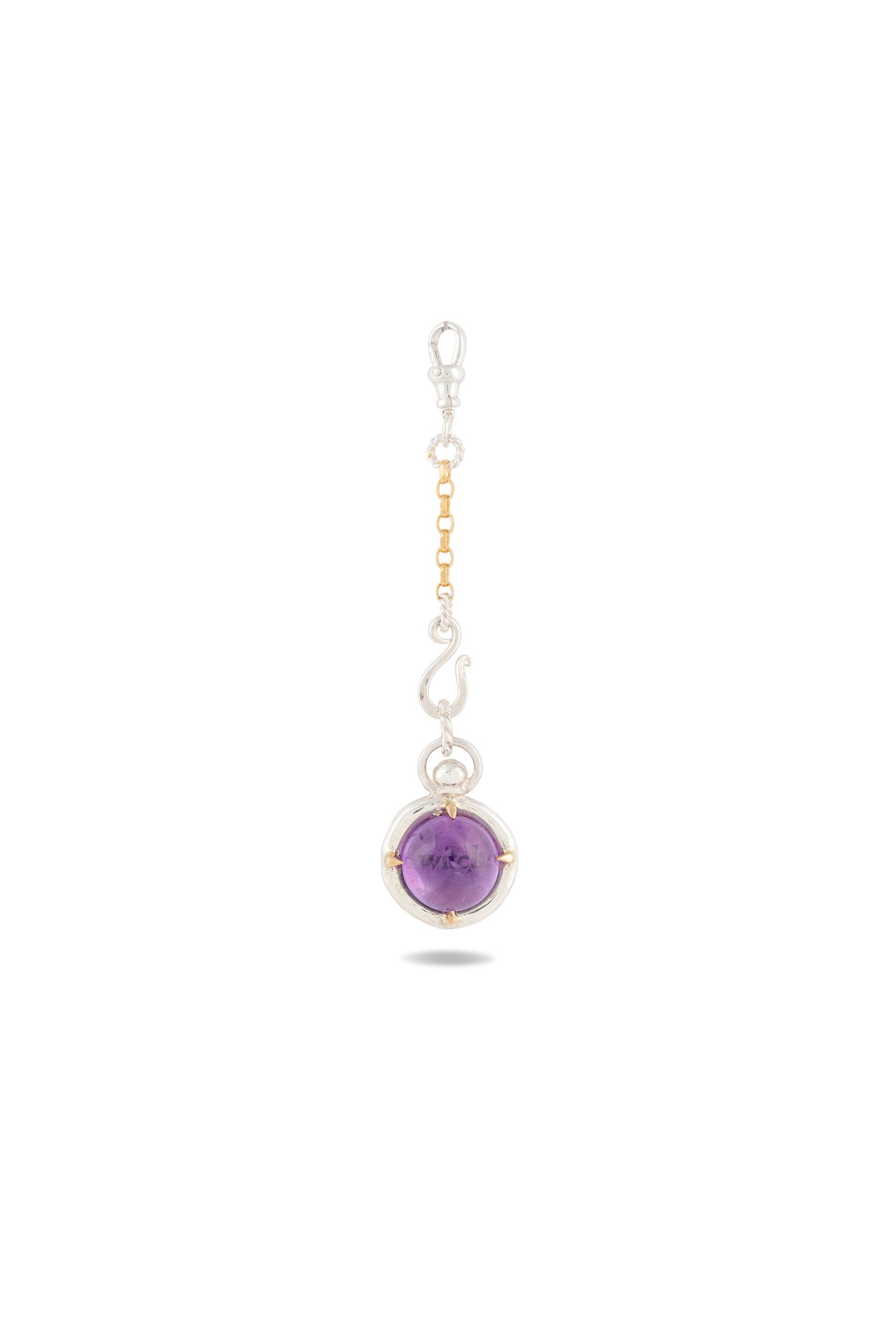 Certainly! Here’s a rewritten sentence using your product data: The ‘There’s A Little Witch In All Of Us’ Charm by Jessica de Lotz Jewellery features a round amethyst cabochon set within a distinctive silver and gold frame, suspended from an ornate chain with alternating silver and gold links, capturing the enchanting spirit of contemporary chatelaine accessories. Shown against a plain white background.