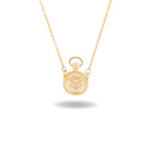 A delicate gold necklace by Jessica de Lotz Jewellery, the Verbenca Botanical Charm Apothecary Top, features a small pendant inspired by a classic apothecary stopper, intricately engraved with ornate initials. Reminiscent of Practical Magic jewelry, the chain is thin and fine, and the pendant casts a soft shadow on a white background.
