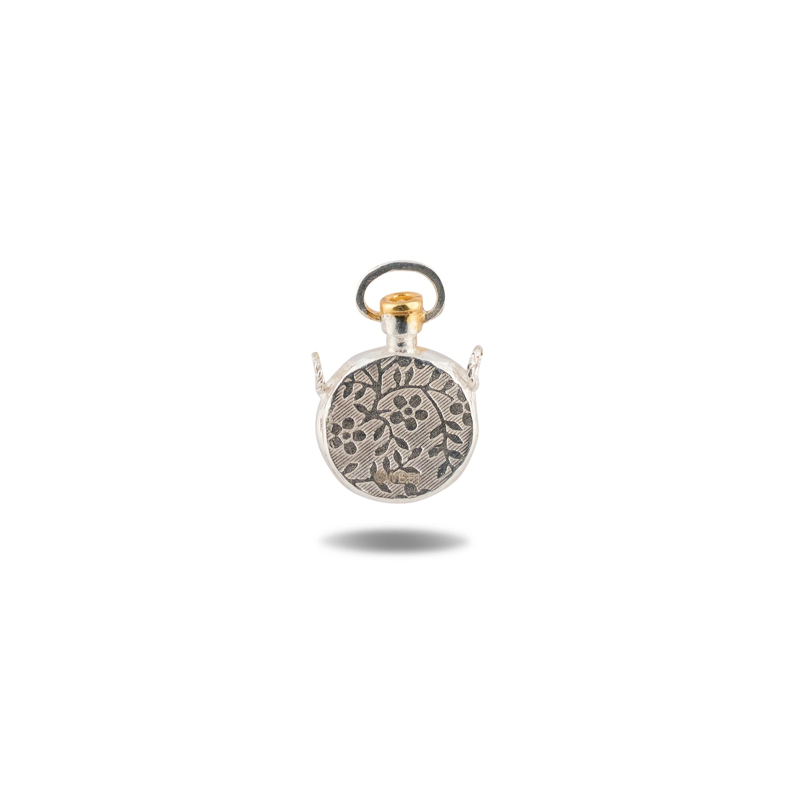A small, round silver charm pendant featuring a floral design and two side loops, topped with a gold-toned ring. Reminiscent of wax seal motifs from the Jessica de Lotz Jewellery collection, this Verbenca Botanical Charm Apothecary Top casts a faint shadow on a white background.
