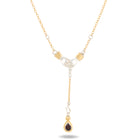 The Chatelaine Hand Necklace with ‘Our Blood’ Drop Charm by Jessica de Lotz Jewellery features two hands clasped at the center, accented with a teardrop-shaped red gemstone and small round white stones along the chain. This delicate piece mixes gold and silver tones in a symmetrical design, evoking vintage charm reminiscent of Practical Magic 2 charms.