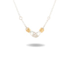 The Chatelaine Hand Necklace by Jessica de Lotz Jewellery features a pendant of two clasped silver hands, each cuffed with a petite gold band. Suspended from a delicate silver chain and set against a plain white background with a soft shadow beneath, this piece evokes the timeless essence of Practical Magic jewelry.