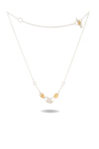 A delicate silver chain necklace, the Chatelaine Hand Necklace by Jessica de Lotz Jewellery, features a small sculpted silver hand charm at its center—reminiscent of classic chatelaine designs—and is flanked by two gold-tone rectangular beads. The beautiful piece is displayed flat on a white background with a soft shadow beneath.