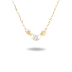 The Chatelaine Hand Necklace by Jessica de Lotz Jewellery features a gold chain adorned with small round crystal accents. At its center sit two intricately detailed hands crafted from translucent material, clasped together in a handshake—a subtle homage to the classic chatelaine hand necklace style. Each hand is finished with an elegant gold cuff at the wrist. Perfect for lovers of Practical Magic-inspired jewelry, this striking piece is photographed on a white background with a soft shadow beneath it.