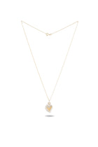 A delicate gold necklace from Jessica de Lotz Jewellery features the Amas Veritas Spell Charm—a heart-shaped pendant with a silver border and a gold heart centerpiece. Laid flat on a white background, the necklace’s fine chain casts a subtle shadow beneath the enchanting pendant, combining elegance with a modern chatelaine flair and evoking the timeless allure of sisterhood charms from Practical Magic 2.