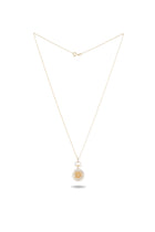 A delicate gold necklace by Jessica de Lotz Jewellery, featuring the Verbena Botanical Apothecary Bottle Charm—a thin chain with a circular pendant showcasing an intricate botanical wax-seal design at its center, photographed against a white background.