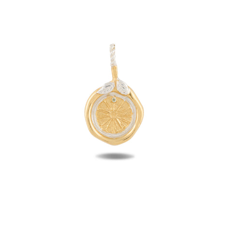 Introducing the Midnight Margarita Charm by Jessica de Lotz Jewellery: a gold and silver pendant artfully shaped like a lemon slice, featuring intricate textured details. Reminiscent of Practical Magic charms, this piece is adorned with two delicate silver leaves at the top and includes a loop for easy attachment to your favorite chain. Photographed against a white background, the pendant casts a subtle shadow, highlighting its unique craftsmanship.