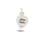 A silver, heart-shaped Amas Veritas Charm by Jessica de Lotz Jewellery features intricate engraving on its top loop. The front displays “Amas Veritas” in elegant script with the Jessica de Lotz mark below—capturing the enchanting spirit of Practical Magic charms. The pendant gently casts a subtle shadow against a white background.