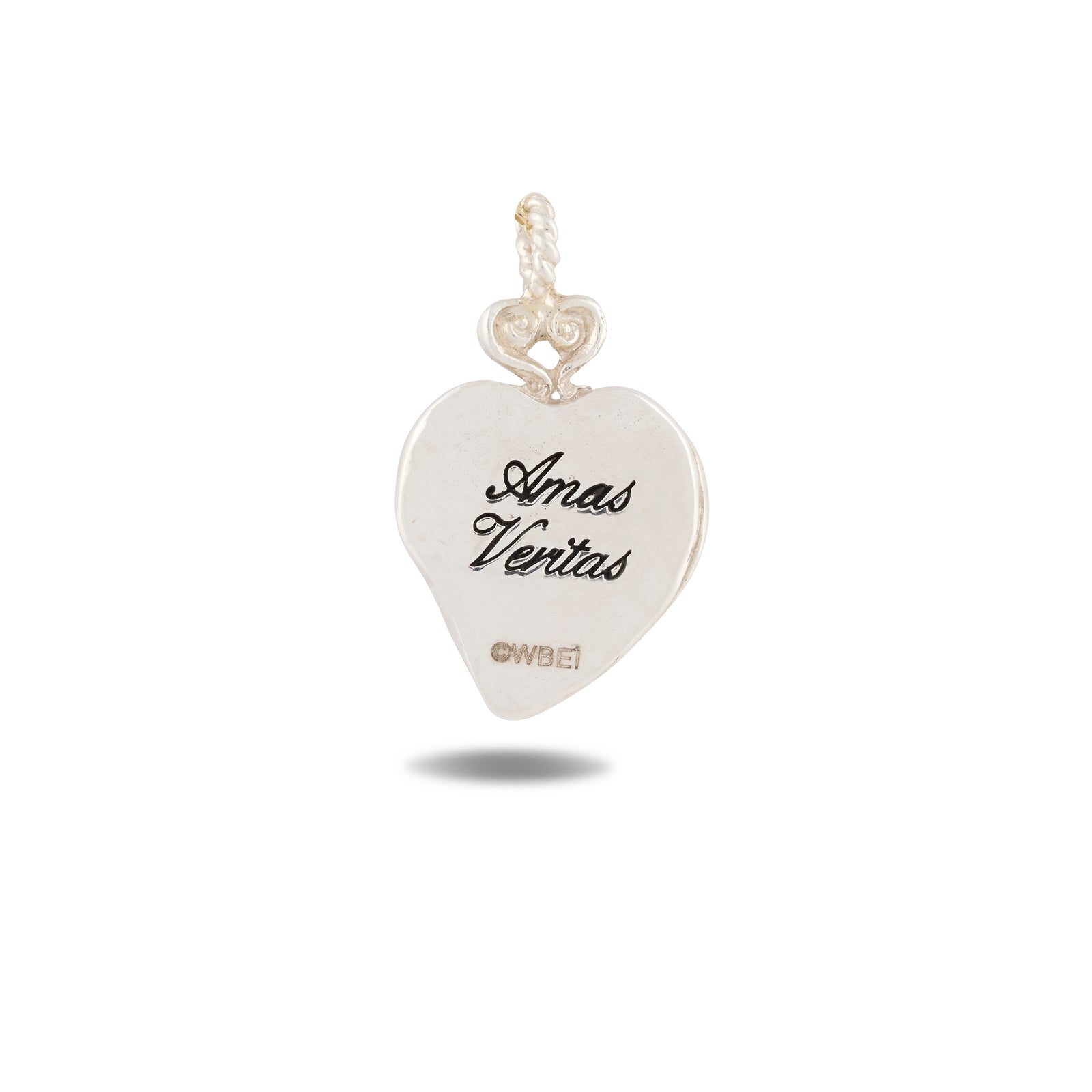 A silver, heart-shaped Amas Veritas Charm by Jessica de Lotz Jewellery features intricate engraving on its top loop. The front displays “Amas Veritas” in elegant script with the Jessica de Lotz mark below—capturing the enchanting spirit of Practical Magic charms. The pendant gently casts a subtle shadow against a white background.