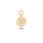 The Verbena Botanical Apothecary Bottle Charm by Jessica de Lotz Jewellery is a small gold and white round pendant with a loop for hanging, featuring an engraved script monogram on its front. Photographed against a white background with a subtle shadow below, this botanical wax-seal charm exudes elegance and timeless appeal, making it a beautiful addition to any sisterhood jewelry collection.