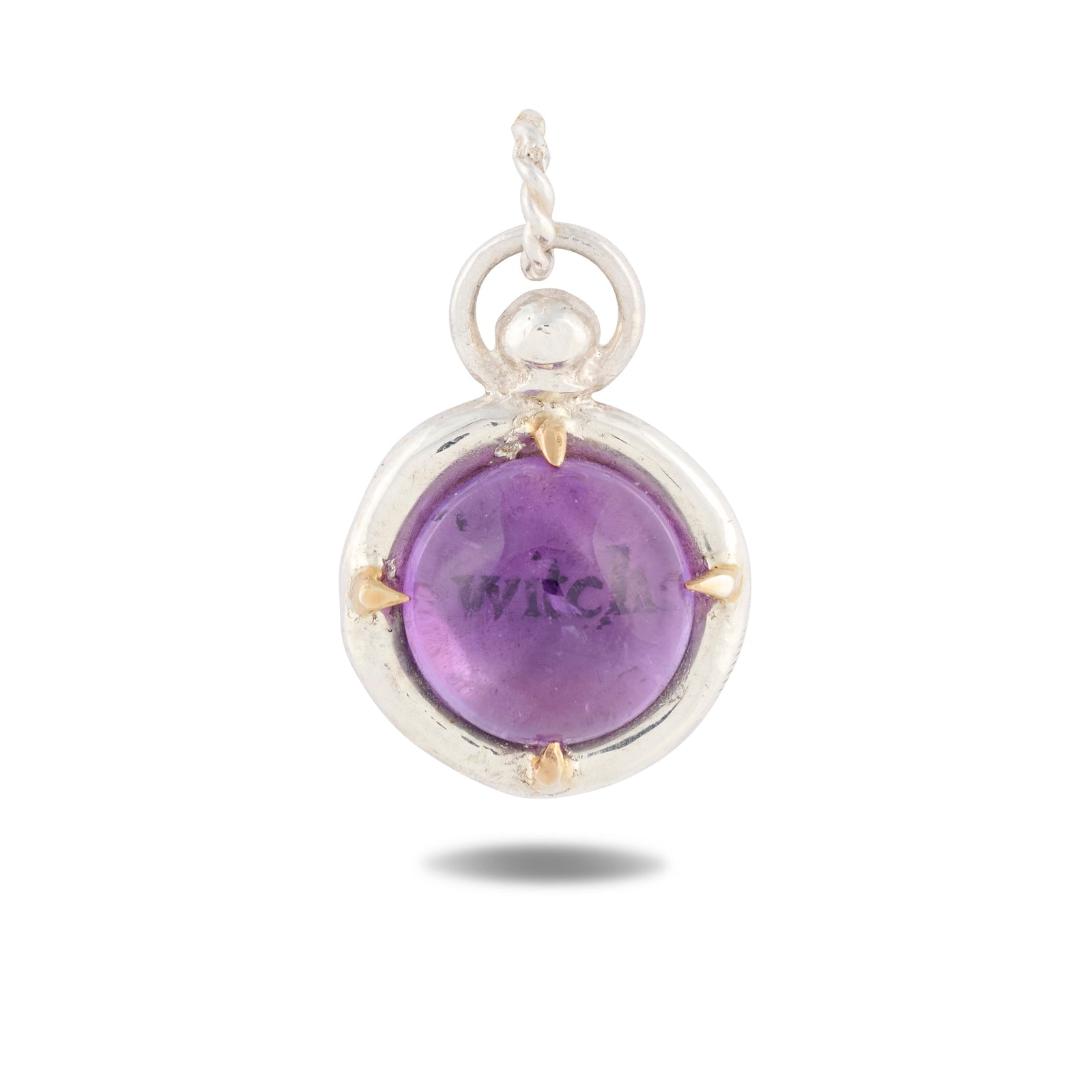 A round purple gemstone pendant titled “There’s A Little Witch In All Of Us Charm” by Jessica de Lotz Jewellery features a smooth, domed cabochon framed in a silver bezel with four gold prongs. Suspended from a twisted silver bail, the pendant echoes the mysterious elegance of Practical Magic 2 and evokes the enchanting allure of wax seal charms, beautifully set against a white background with a soft shadow below.