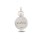 A circular silver charm from Jessica de Lotz Jewellery, named the “There’s A Little Witch In All Of Us Charm,” features a small loop at the top, evoking vintage wax seal designs. Engraved in cursive are the words there’s a little witch in all of us, with ©WBEI in a simple font beneath—a graceful homage to the magical world of Practical Magic 2. Presented against a clean white background.