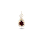 Certainly! Here is a rewritten version of the sentence using the given product data: The Our Blood Pendant by Jessica de Lotz Jewellery features a teardrop-shaped, deep red gemstone set in a gold bezel and framed by a silver border—evoking the enchanting charms often found in Jessica de Lotz’s creations. The pendant includes a small, textured silver loop at the top for easy attachment to your favorite chain. The faceted gemstone casts a subtle shadow below, imparting an air of mysterious allure.