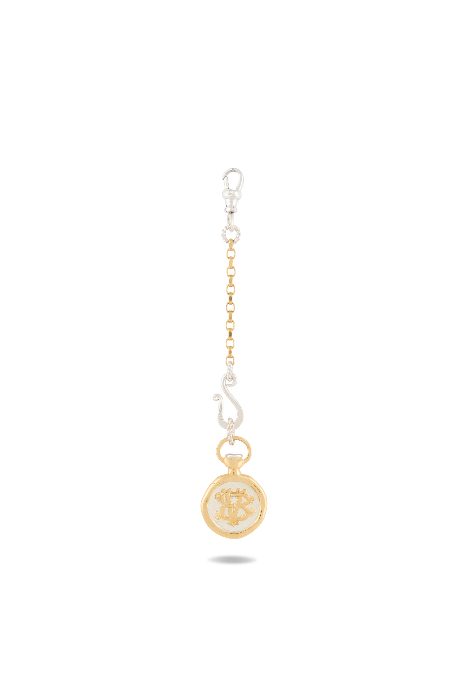 A gold and silver Verbena Botanical Apothecary Bottle Charm by Jessica de Lotz Jewellery, featuring a chain link design with a lobster clasp at the top, an abstract silver S-shaped charm inspired by sisterhood jewelry, and a round gold botanical wax-seal charm with an ornate center design—all beautifully displayed against a white background.