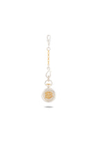 A Verbena Botanical Apothecary Bottle Charm by Jessica de Lotz Jewellery is centered on a white background. The round charm case features an ornate design reminiscent of sisterhood jewelry, while the attached chain showcases alternating gold and silver links. A subtle shadow sits beneath the charm.