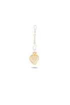 A gold and silver Amas Veritas Spell Charm keychain by Jessica de Lotz Jewellery features a heart-shaped pendant with intricate designs inside, reminiscent of sisterhood charms found in a modern chatelaine. The heart is attached to a decorative clasp adorned with beaded and swirl details, casting a soft shadow below on a white background.