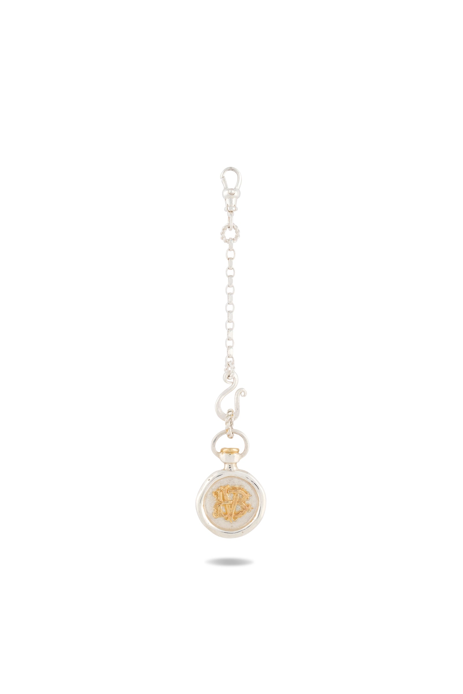 A silver chain keychain from Jessica de Lotz Jewellery, named the Verbena Botanical Apothecary Bottle Charm. It features a round pendant with a raised gold Medusa head at its center, set within a clear, oval-shaped frame inspired by botanical wax-seal charm designs. The chain is finished with a lobster clasp for easy attachment. Displayed against a plain white background.