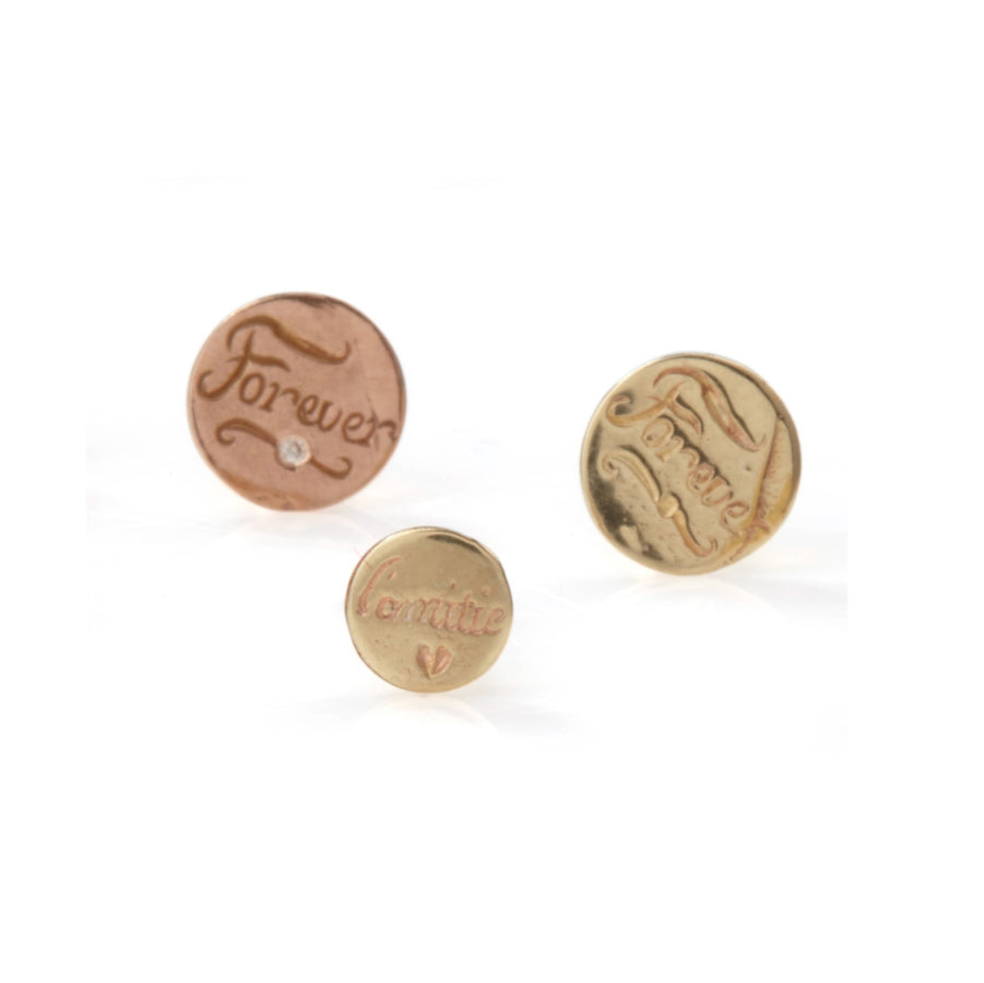 JdL Jewellery’s Sentimental Hand Engraved Studs feature round gold and rose gold pins with “Forever” or “Amire” (with a heart) engraved, each single stud showcasing a vintage, handcrafted charm.