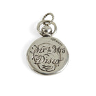 A round silver Hand or Paw Imprint Charm by Jessica de Lotz Jewellery features a twisted loop for attaching to a chain, personalized engraving, a small hallmark above the inscription, and is photographed on a plain white background.