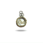The Tied Charm by Jessica de Lotz Jewellery is a round silver pendant with a gold braided border and “God” in cursive, resembling a wax seal. It features a silver loop for attaching to a chain and is shown on a white background.