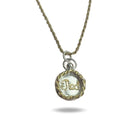 The Tied Charm necklace by Jessica de Lotz Jewellery features a gold rope chain and round pendant edged in twisted gold and silver. Inside, white fabric is embroidered with “Fidel” in gold thread, all casting a soft shadow on a white background.