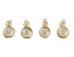 Personalise your JdL Jewellery with the Charm Add-On—four gold and silver wax seal-style charms, each with a raised letter (M, A, K, E), gold edges, and looped tops for easy attachment to your favourite necklace.